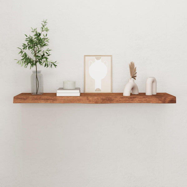 a wooden shelf with various decorative items on it, including a plant, a framed picture, and some white vases.