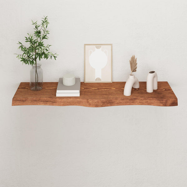 a wooden shelf with various decorative items on it, including a plant, a framed picture, and some white vases.