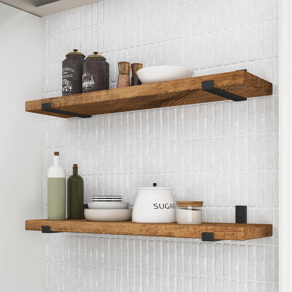 a set of wooden shelves mounted on a white tiled wall, displaying various kitchen items such as bottles, a bowl, and a sugar container.