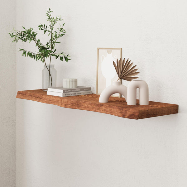 a wooden shelf with various decorative items on it, including a plant, books, and a vase.