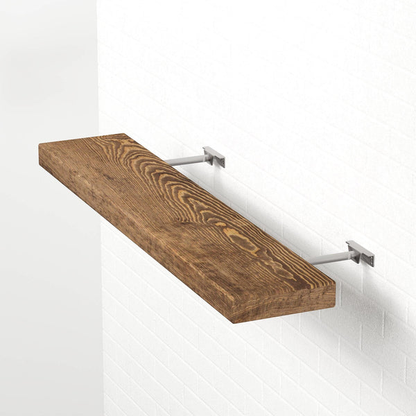 A wooden shelf mounted on a white wall, with a metal bracket attached to the wall.