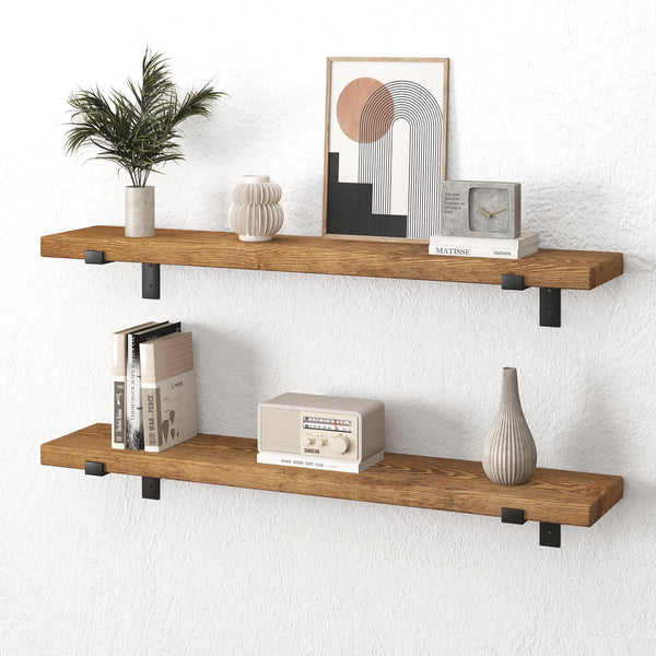 two wooden shelves mounted on a white wall, each holding various decorative items such as a plant, a clock, a book, and a radio.