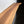 a wooden countertop or shelf with a natural wood grain texture and a dark background.