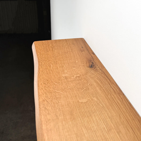 a wooden surface with a natural, weathered texture, likely made of oak or a similar type of wood.