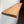 A wooden shelf mounted on a wall, with a natural, light-colored finish.