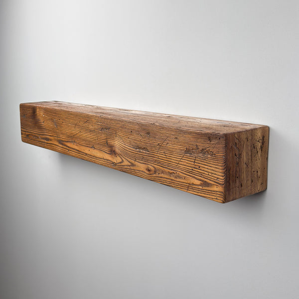 A wooden shelf mounted on a white wall.