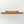 A yellow spirit level is mounted on a wooden shelf against a white wall.