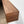 a wooden shelf or ledge mounted on a wall, with a warm, natural wood grain texture.