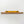 A yellow spirit level is mounted on a wooden shelf against a white wall.